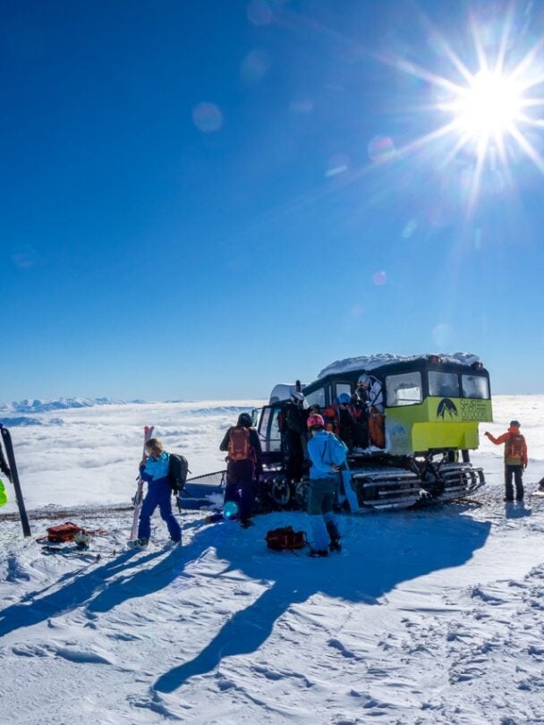 Giving the skis to skiers from a snowcat in Macedonia