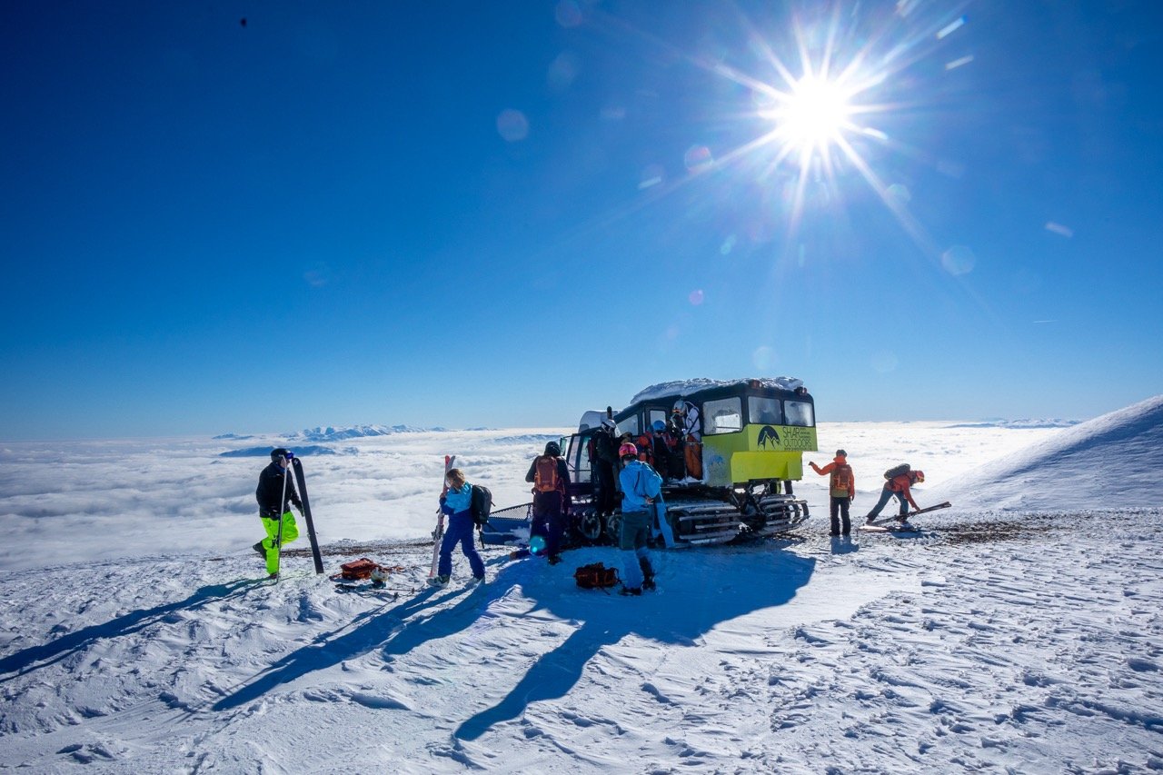 Skiers getting ready to ski near a snowcat in Macedonia