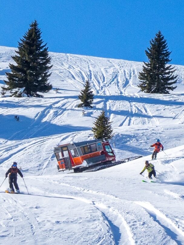 Giving the skis to skiers from a snowcat in Macedonia