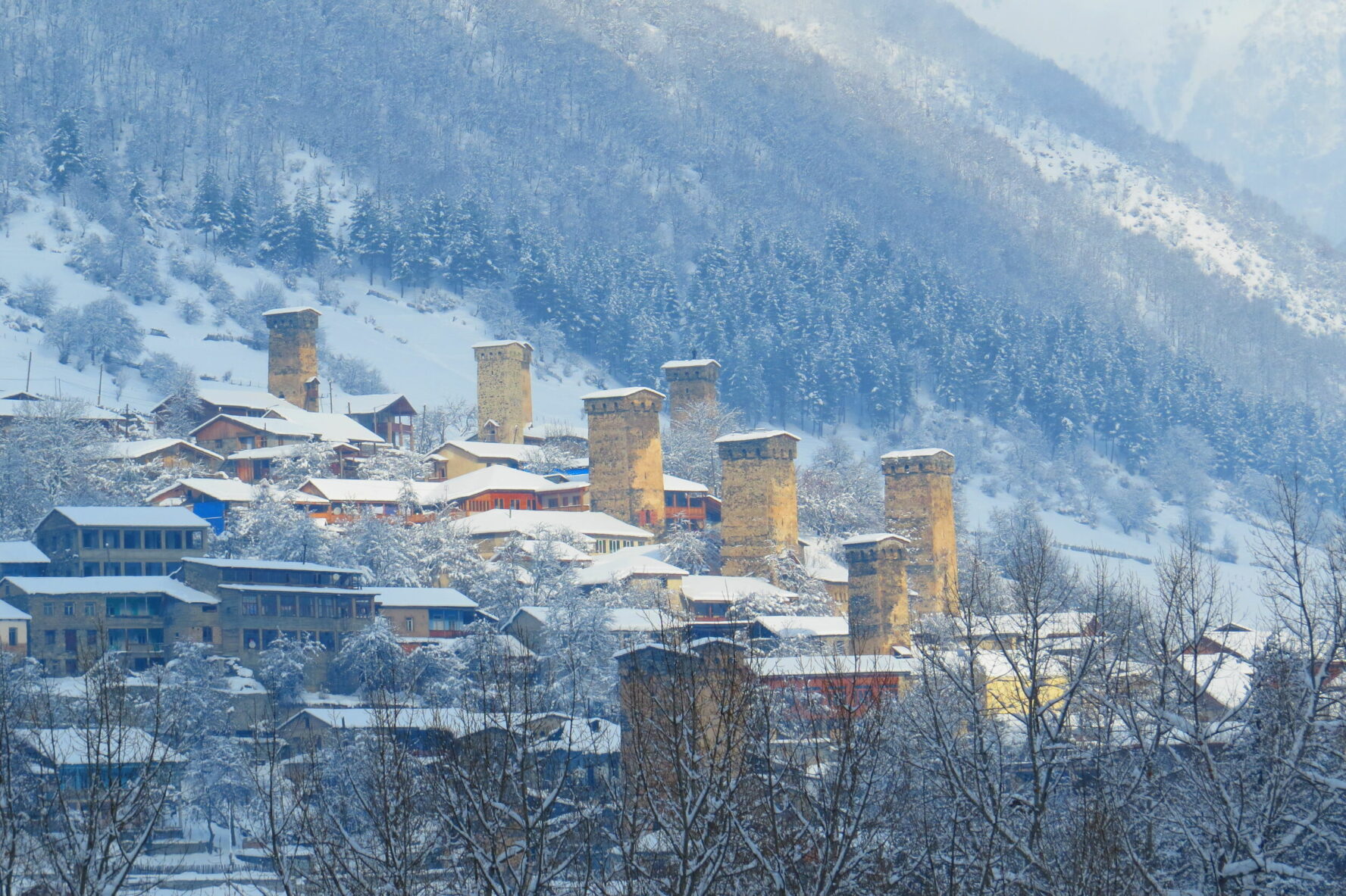 The stone houses and towers of Mestia on a snowy day