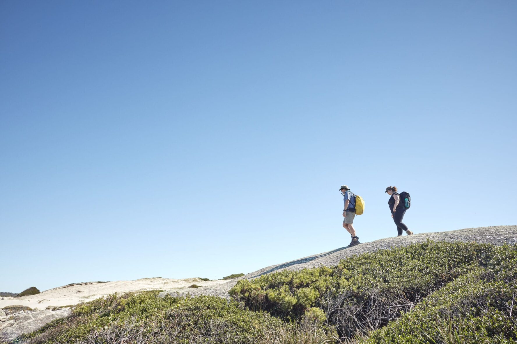Two hikers in the Bay of Fires