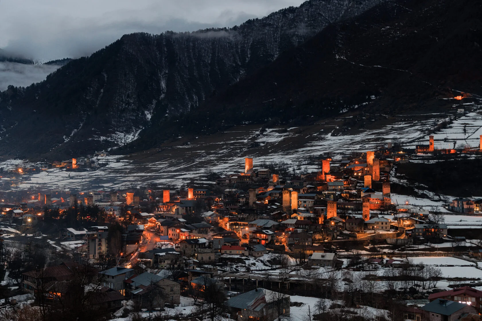 Warm lights illuminating Mestia and the snowy mountain valley