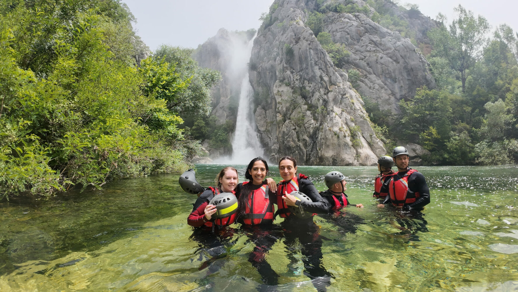 Adventurers posing in river Cetina