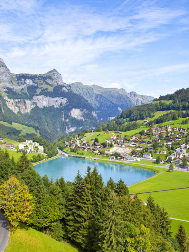 Hikers on a trail beside the Oeschinen lake, Swiss Alps.
