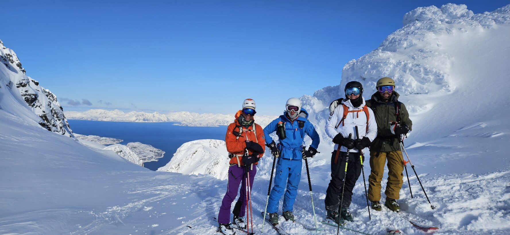 Four skiers on a snowy mountain in Norway