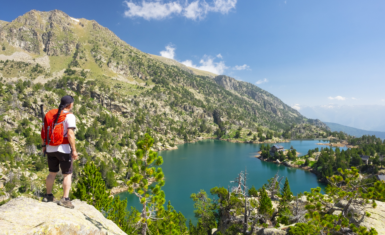 Hiker near a mountain lake in the Pyrenees