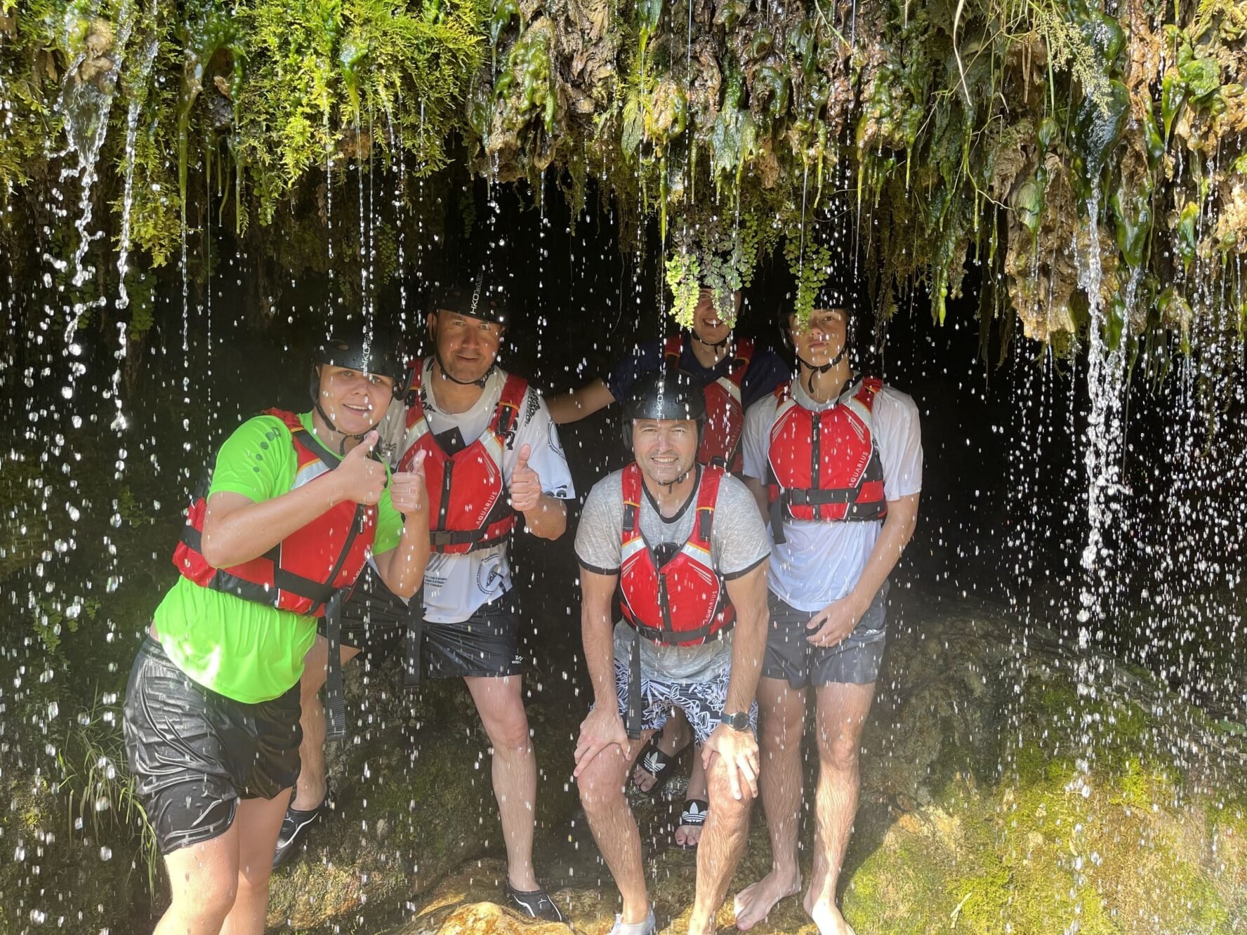 People under the waterfall