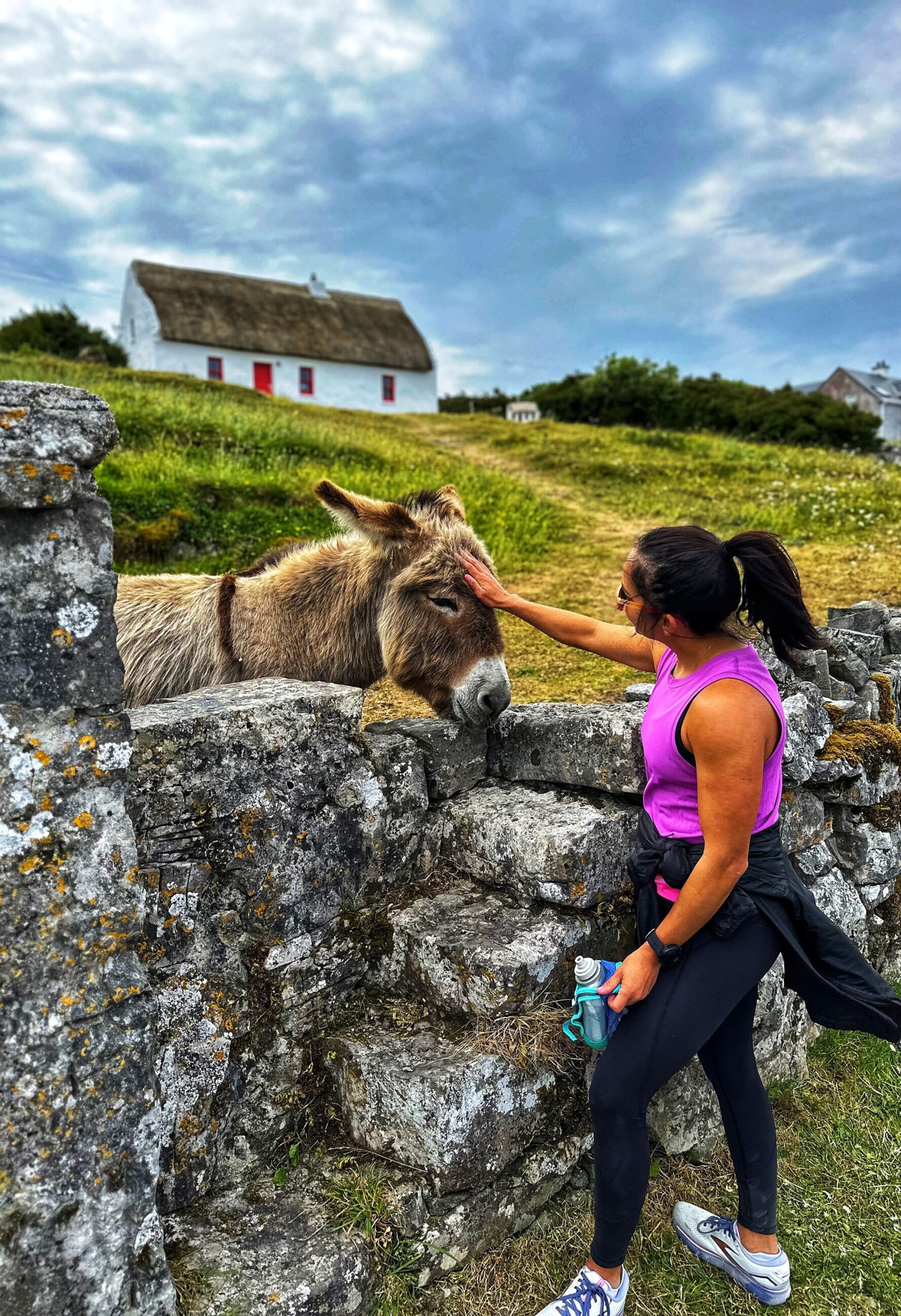 Runner petting a donkey