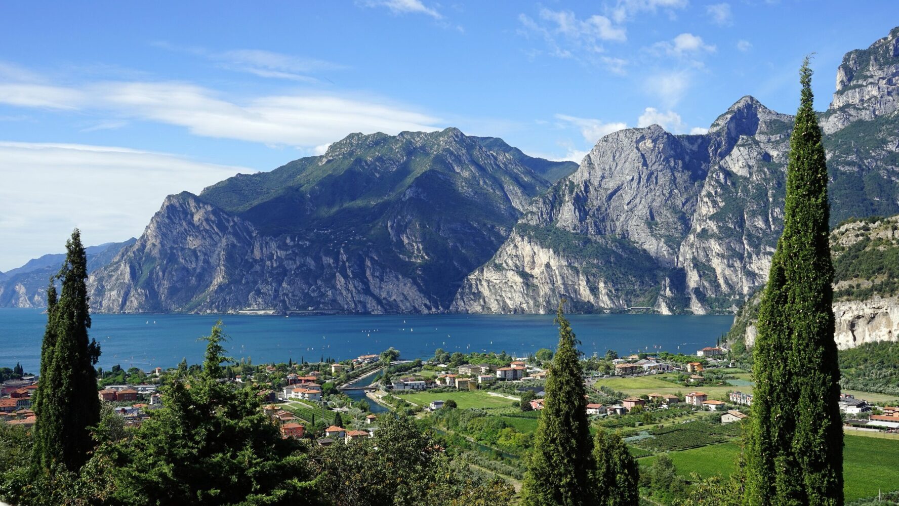 Scenic view of Lake Garda with surrounding mountains and town in Italy