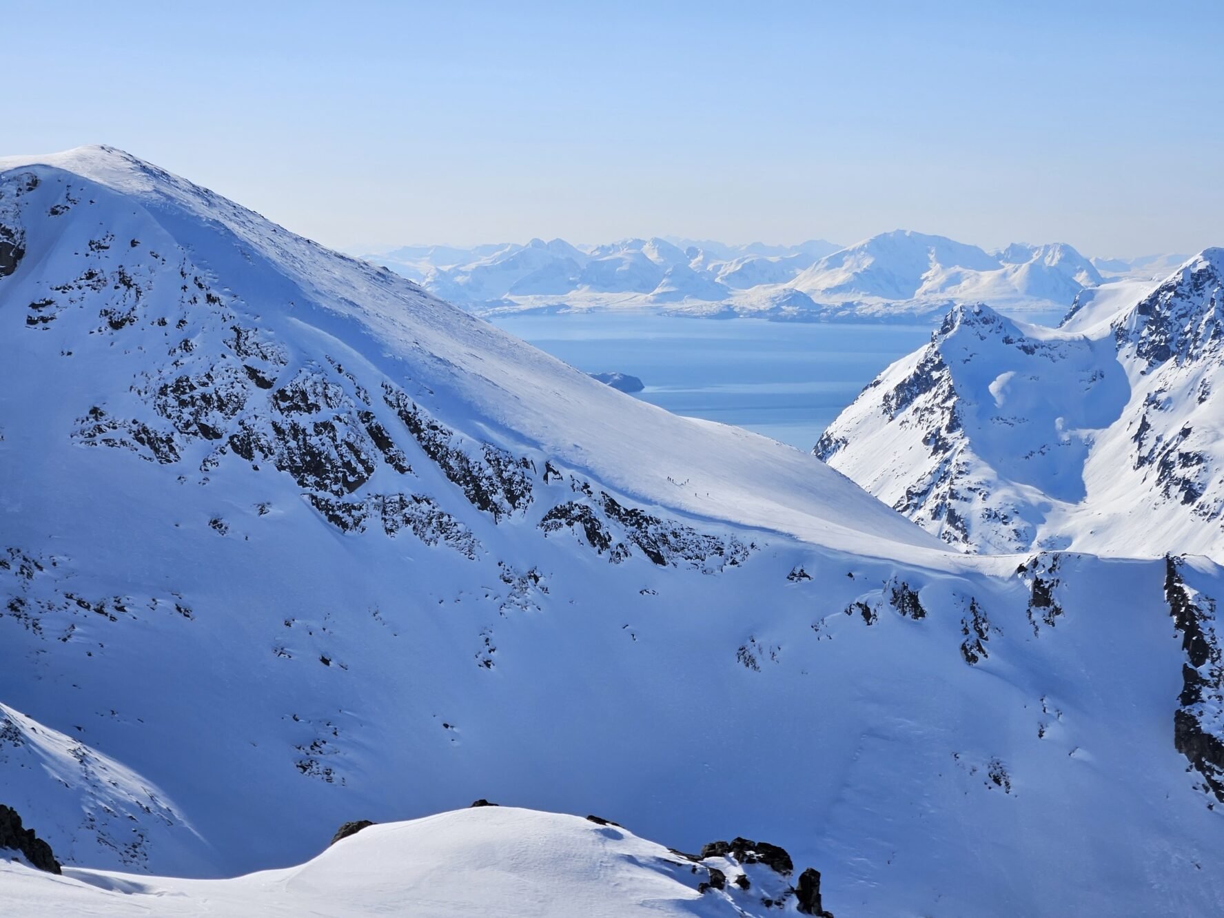 Snow-covered mountain peaks with a view of the sea in Norway