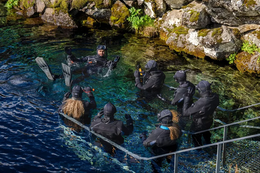 Swimmers in diving suits