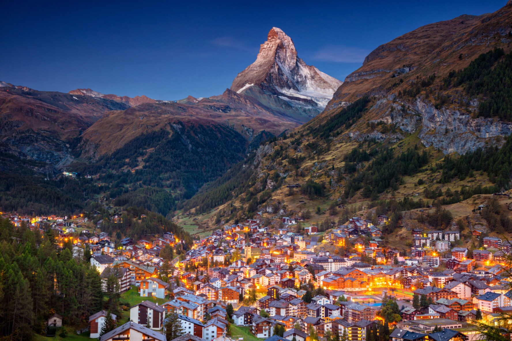 The village of Zermatt with the Matterhorn in the background during twilight