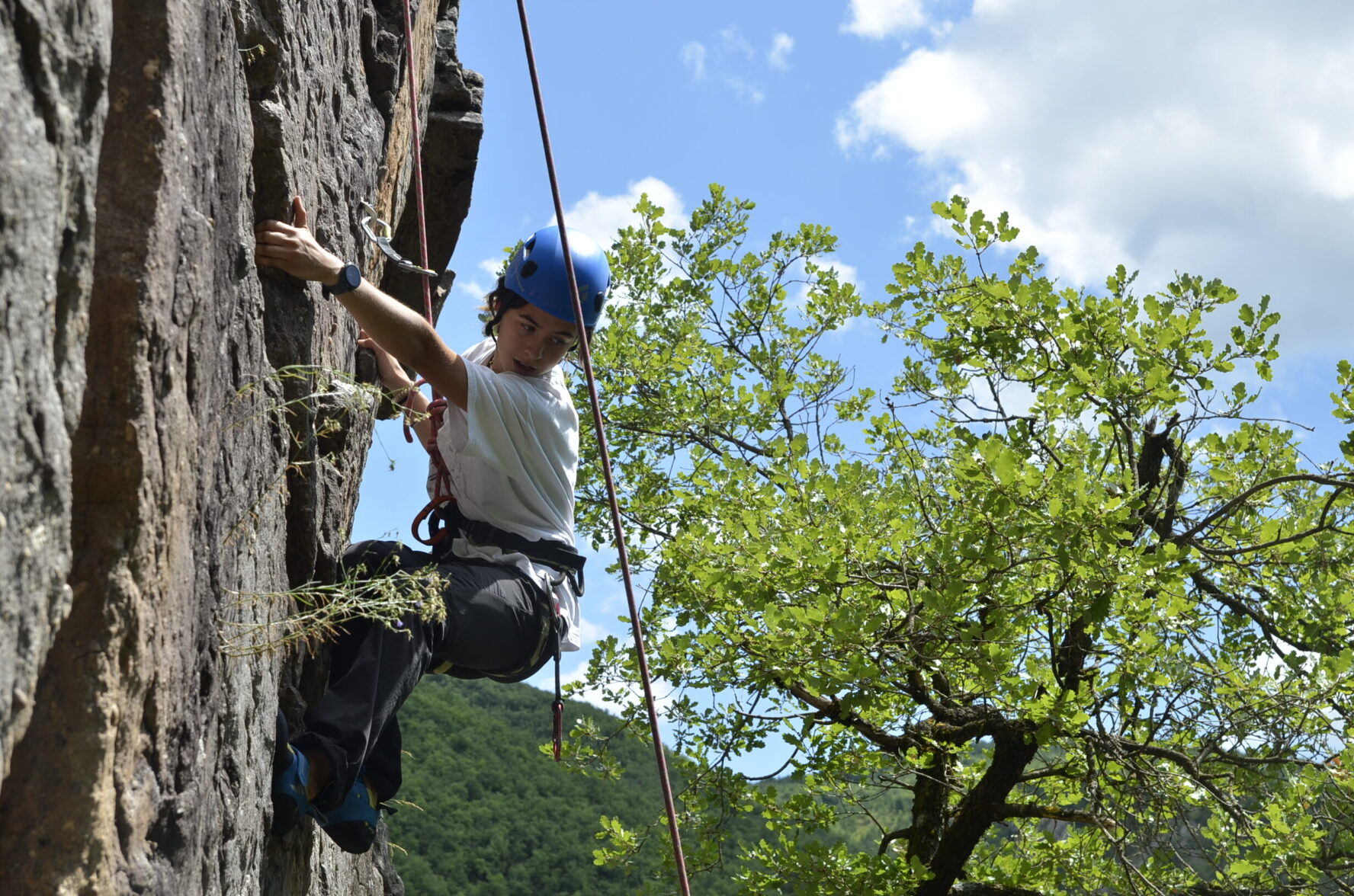 Woman climbing granite in the Catalan Pyrenees