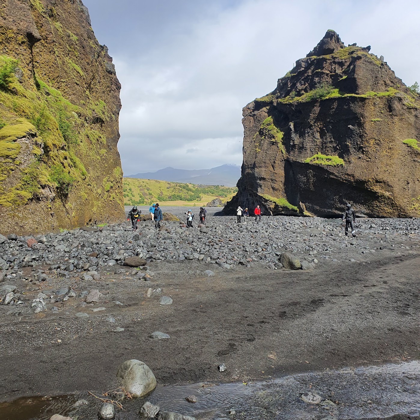 Hikers exploring a rocky canyon near Thorsmork valley, Iceland