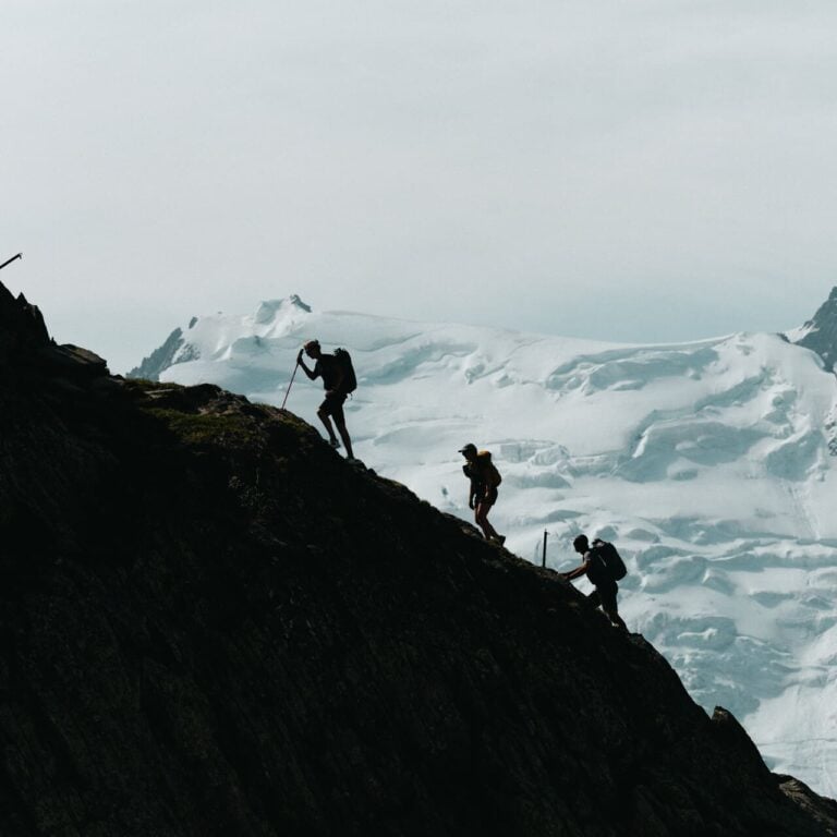 Hikers silhouette glacier ridge