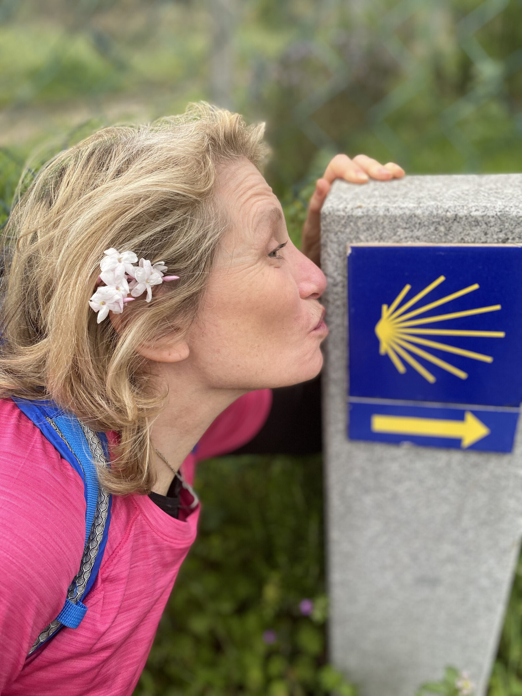 Pilgrim posing next to the Camino sign
