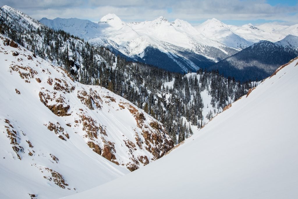 Snow-capped mountains with forested slopes