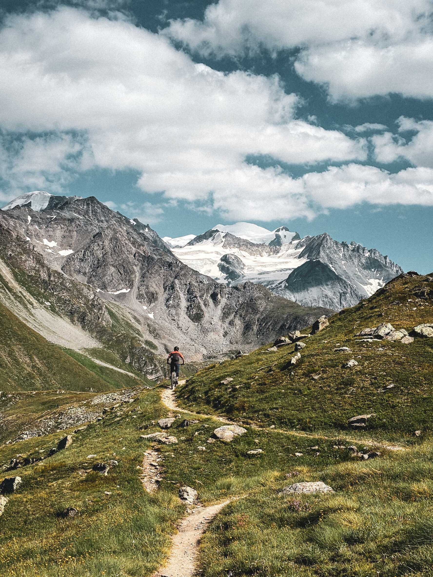 Biking on a trail overlooking the Alps in Valais