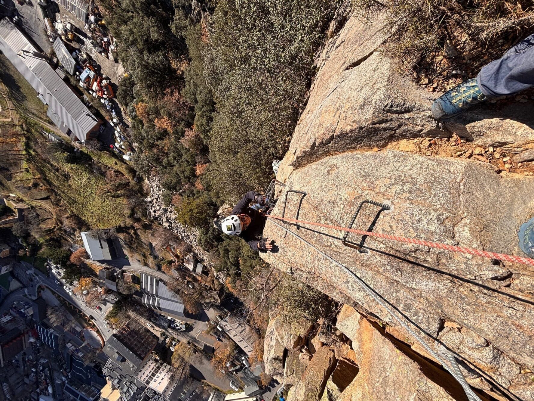 Climber high up on the via ferrata in Andorra