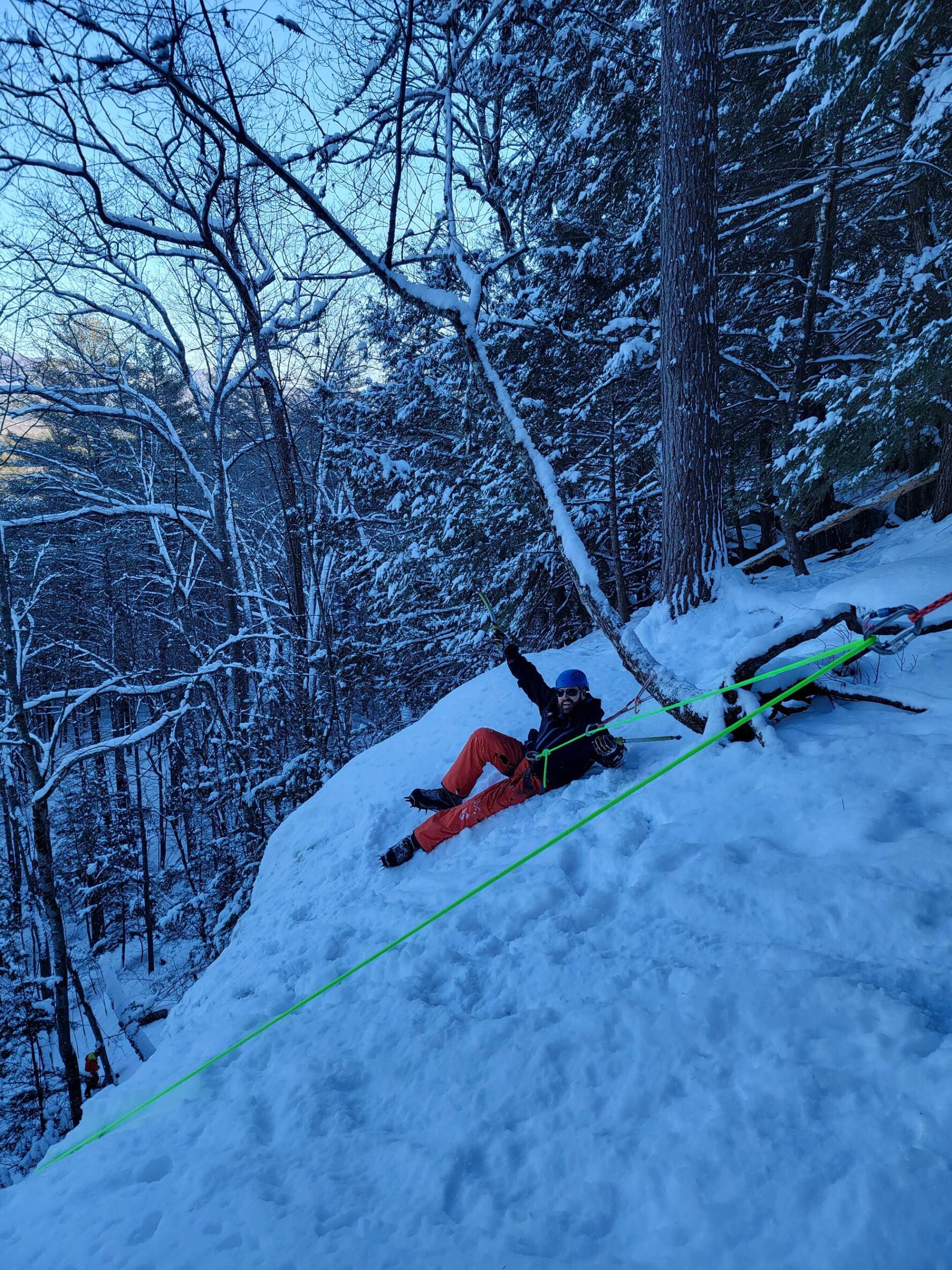 Climber smiling on a snowy slope in New Hampshire