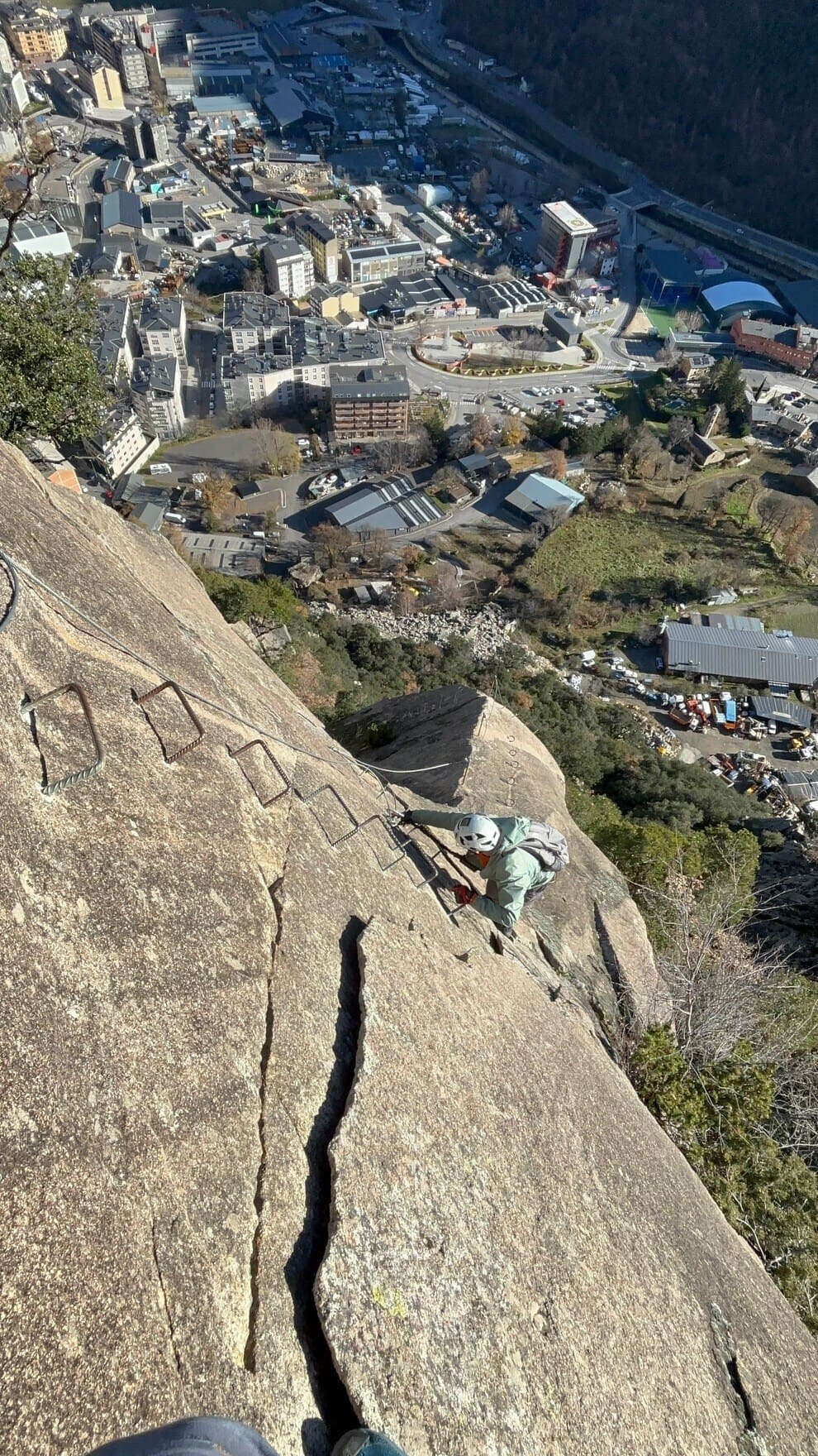 Climbing the via ferrata Andorra above an urban area
