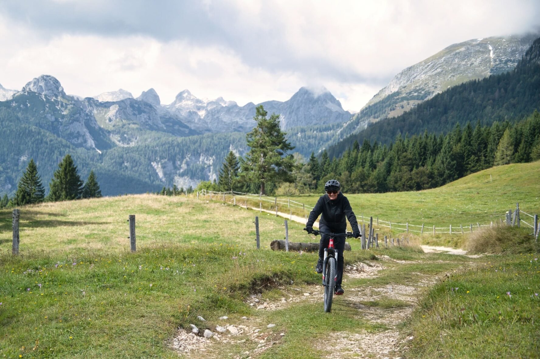 Cyclist smiling while on an e-MTB in Julian Alps