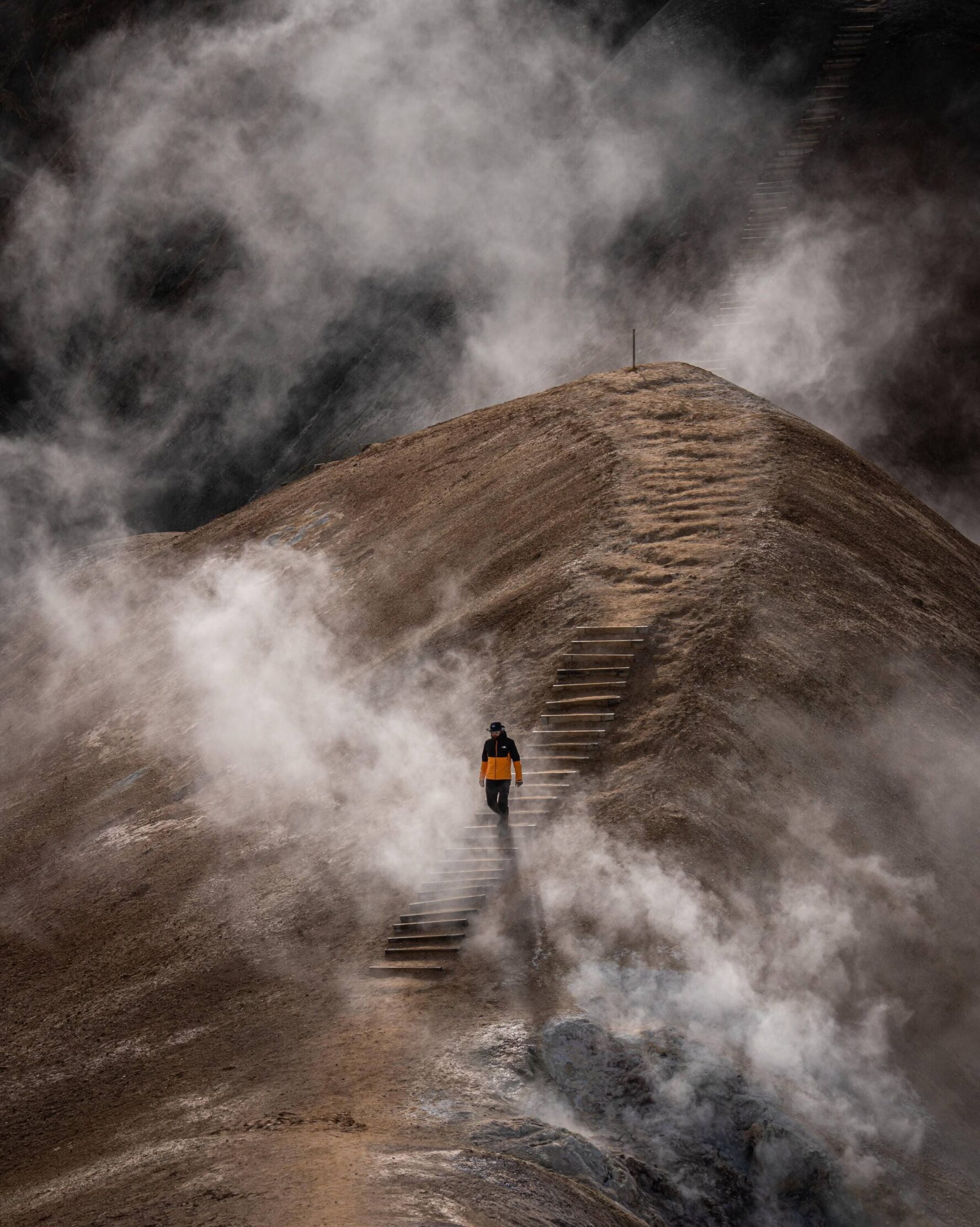 Hiker climbing down with steam on the side