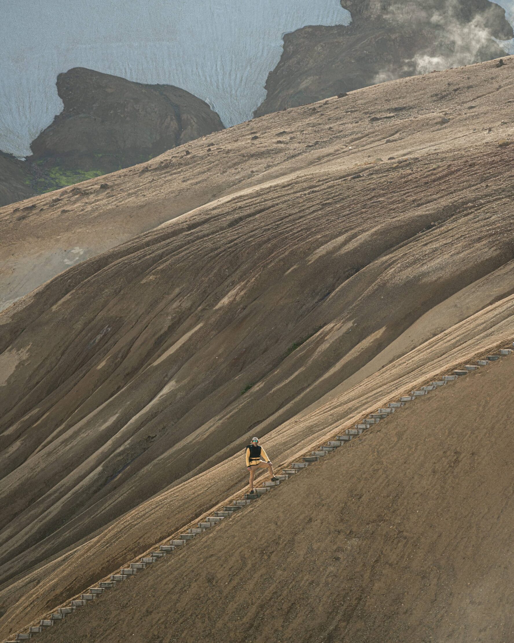 Hiker climbing to the top in Iceland