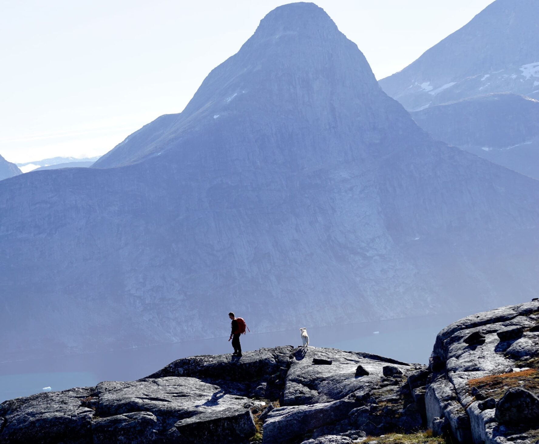 Hiker on the edge of a cliff in Greenland