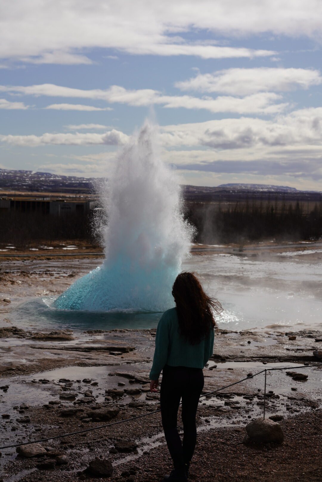 Hiker watching a geysir