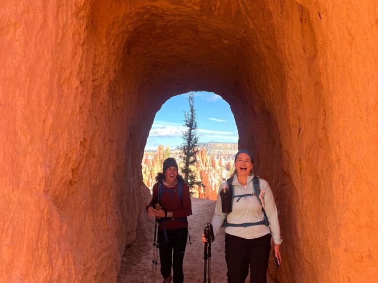 Two hikers hiking the Peekaboo trail on the Zion and Bryce hiking tour