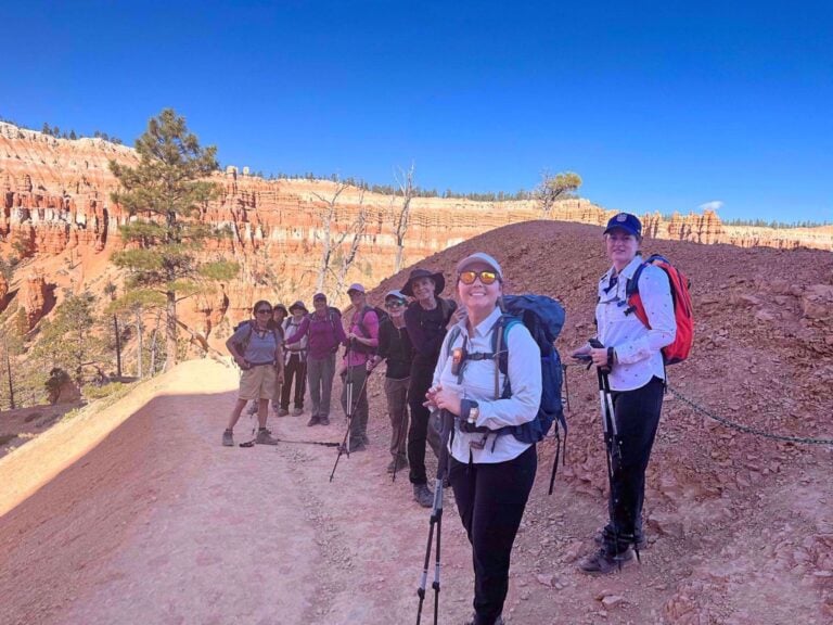 Hikers smiling on a trail in Zion National Park
