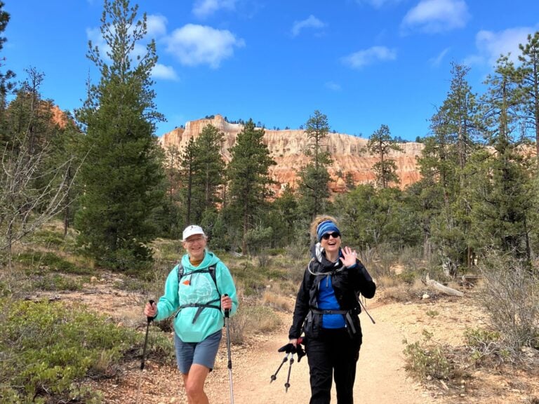 Hikers waving with Bryce Canyon in the background