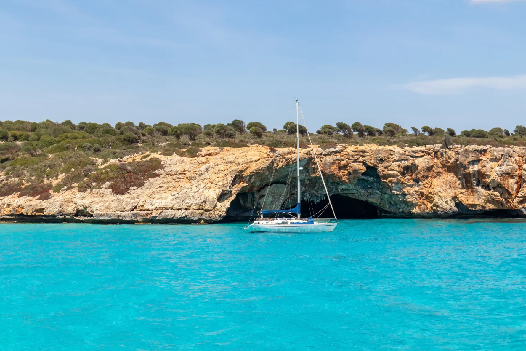 A sailboat in the crystal clear sea in Mallorca