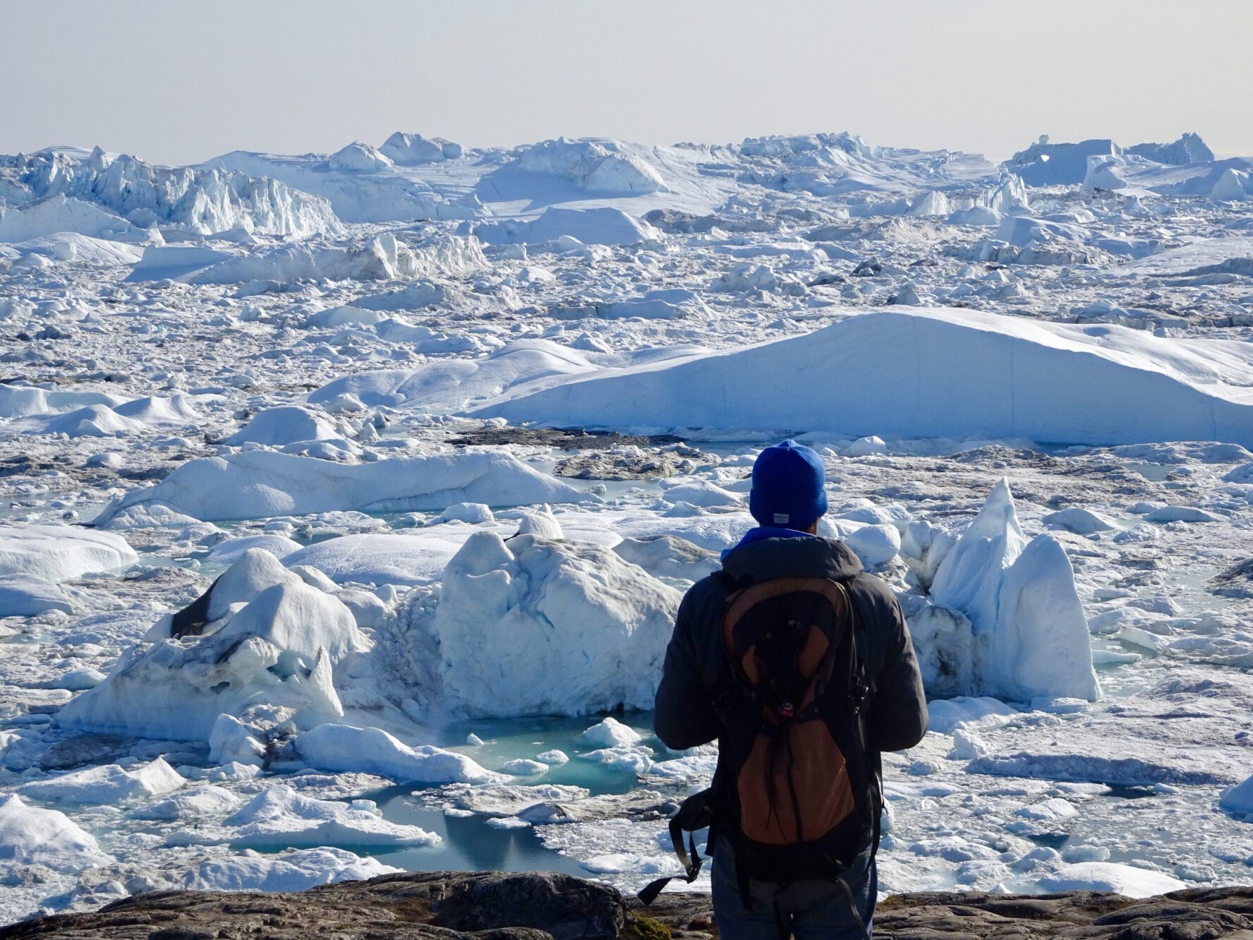Person overlooking a frozen glacier landscape