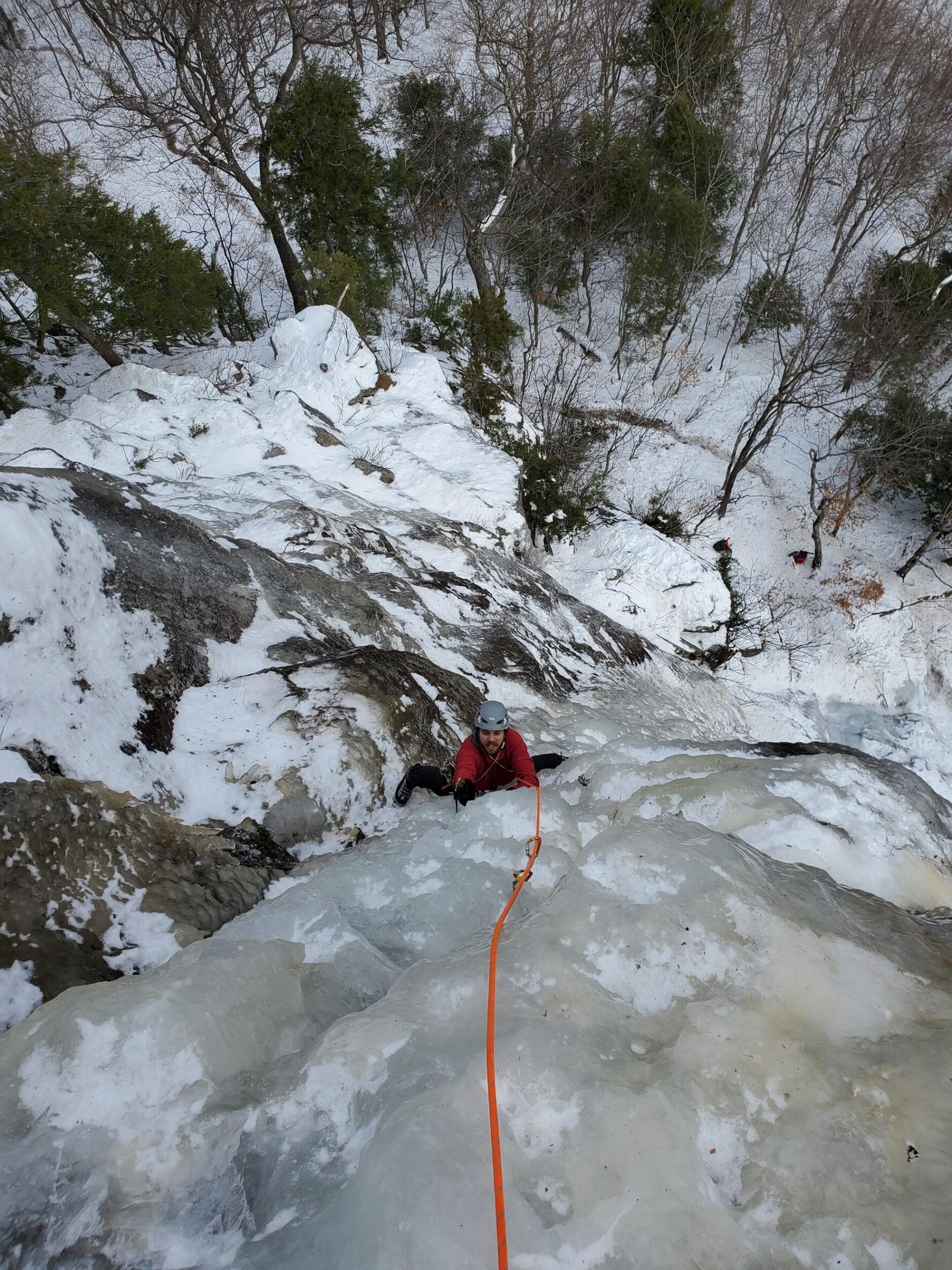 Person ice climbing a frozen waterfall in New Hampshire