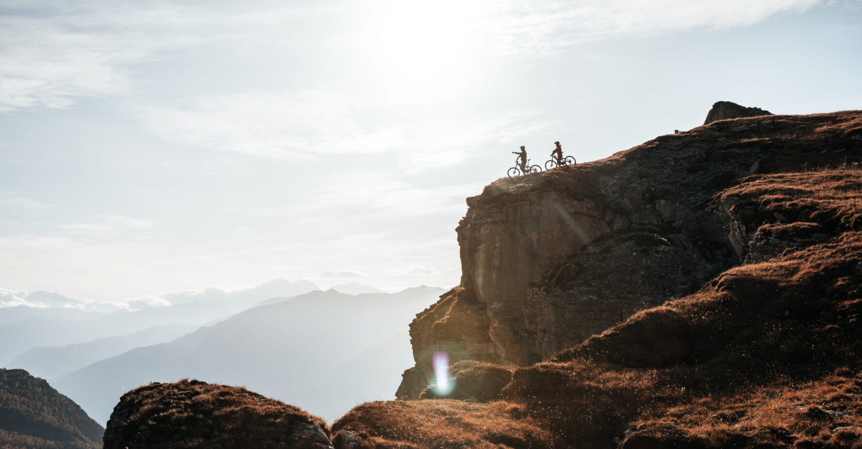 Sunset and two MTBers in the Swiss Alps