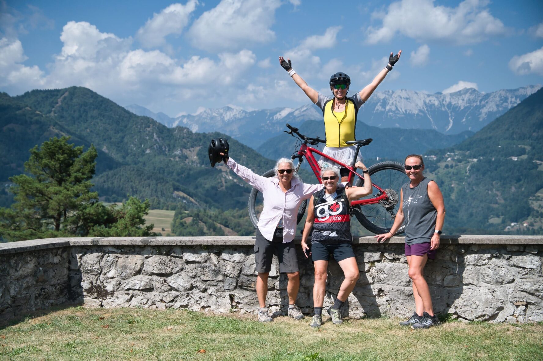Three people e-MTB Julian Alps pose with their bikes