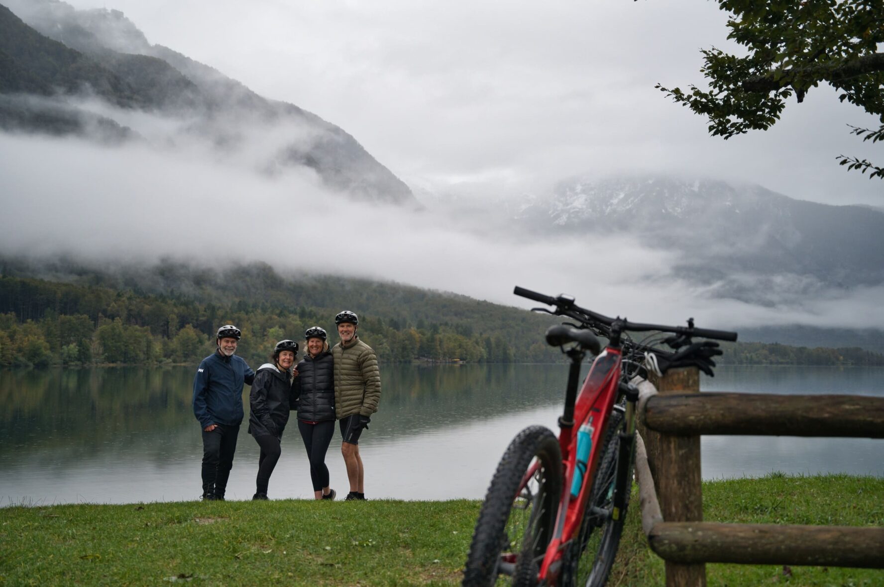 Three people beside a lake in the Julian Alps