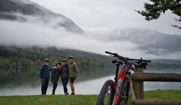 Three people beside a lake in the Julian Alps