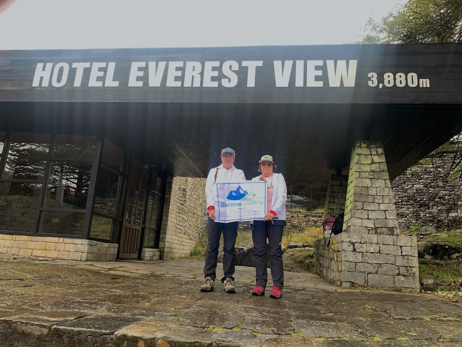 Trekkers with their trip certificate in front of the Everest View hotel