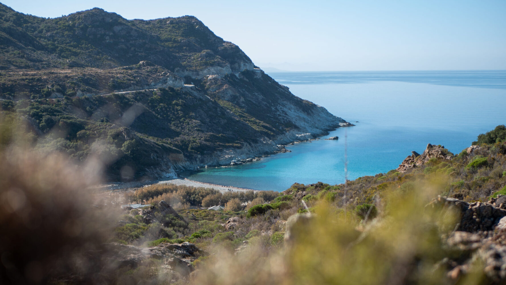 A beach on the coast of Corsica seen from the road on the North Corsica bike holidays