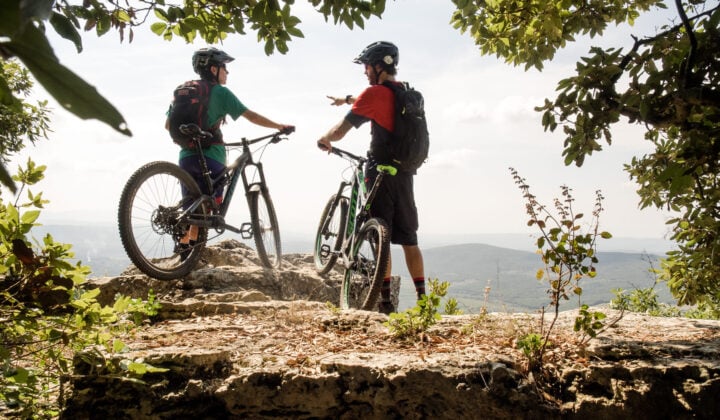 Bikers between leaves high up on the Tuscany e-bike trip