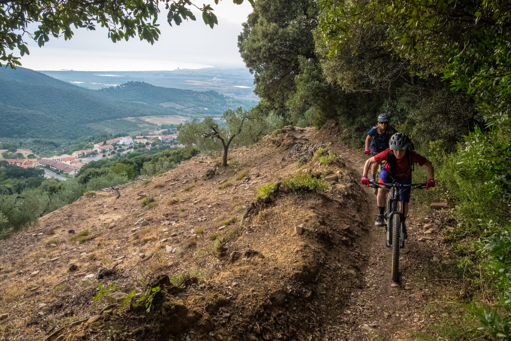 Bikers on a trail overlooking a village on the Tuscany e-bike trip