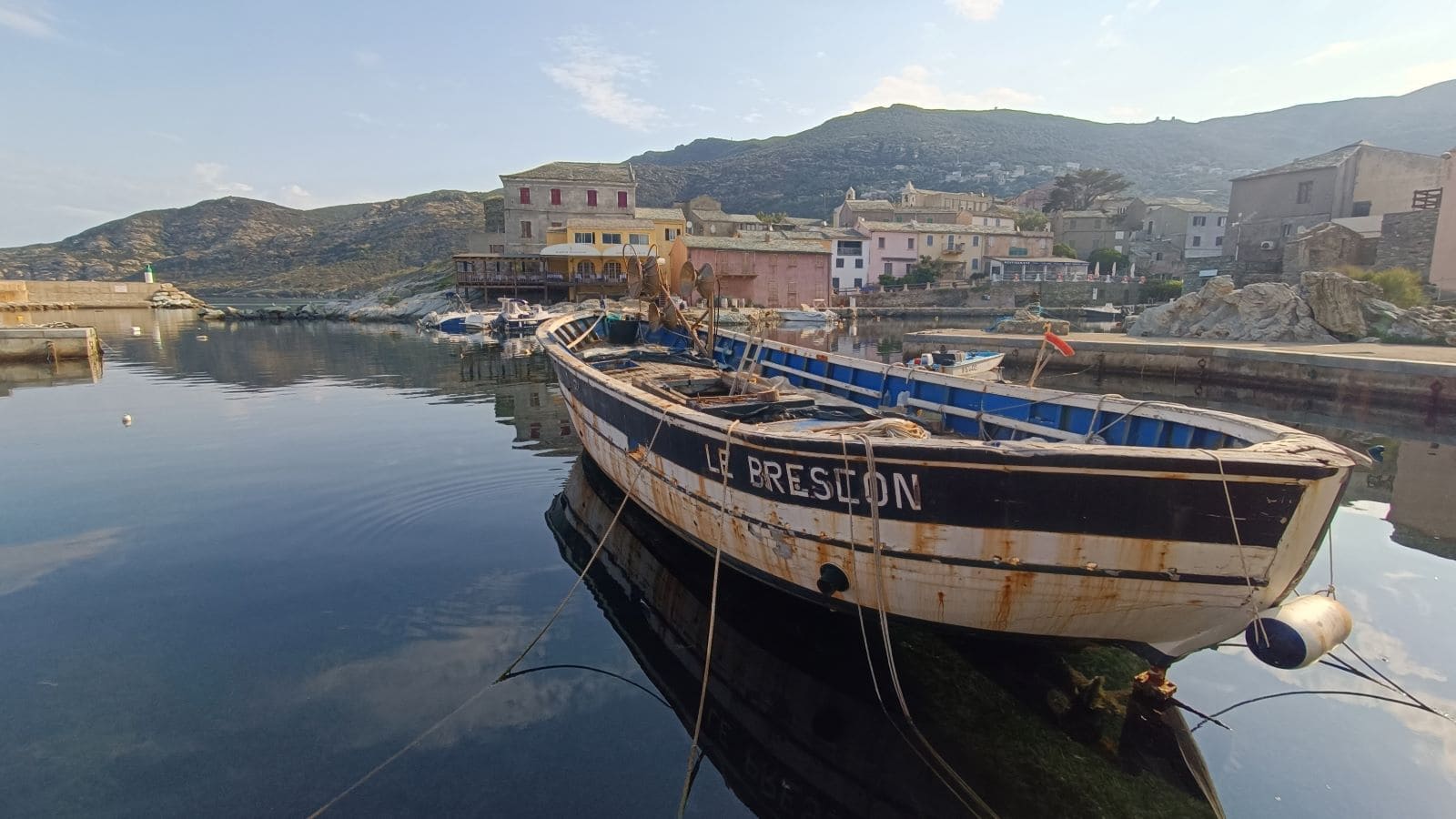 A boat in Centuri harbor, the second stop of the North Corsica bike holidays