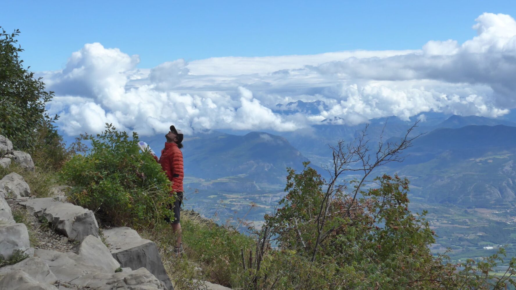 Climber near crag in Ceuse with a beautiful landscape in the background