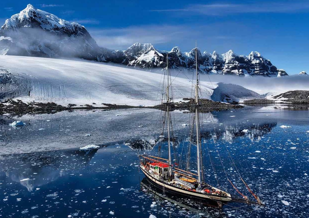 Elsi boat in frozen sea in Antarctica