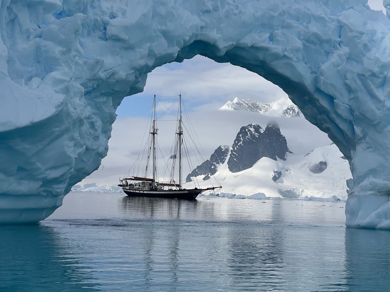 The Elsi boat sailing under an ice formation