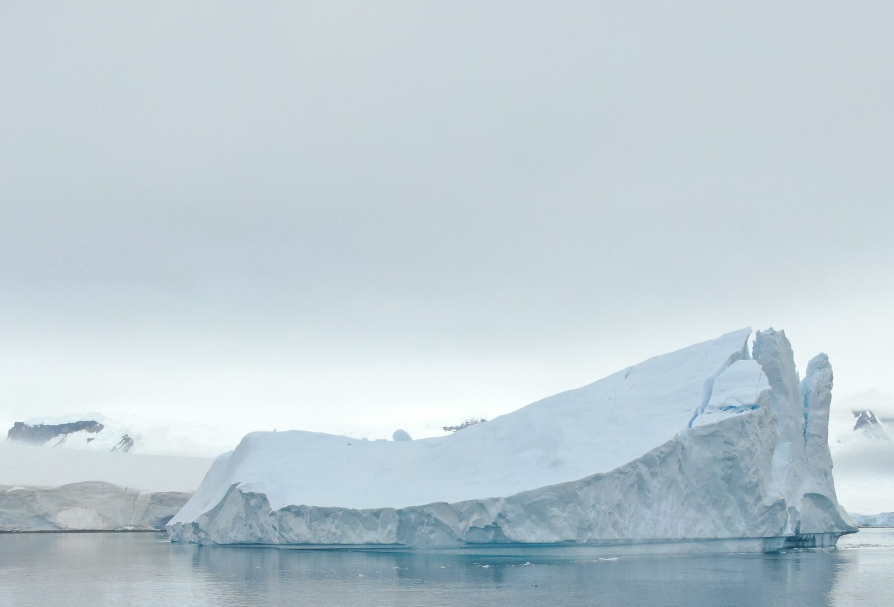 A glacier in Antarctica with fog behind it