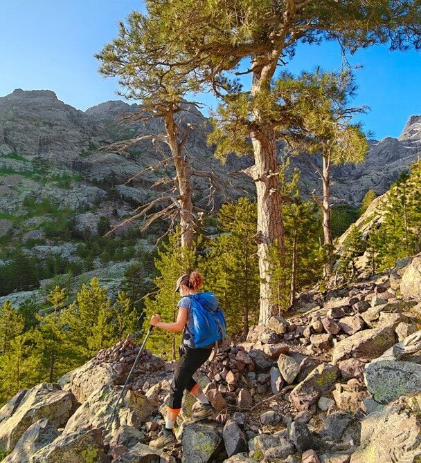 Female hiker above sea, Corsica